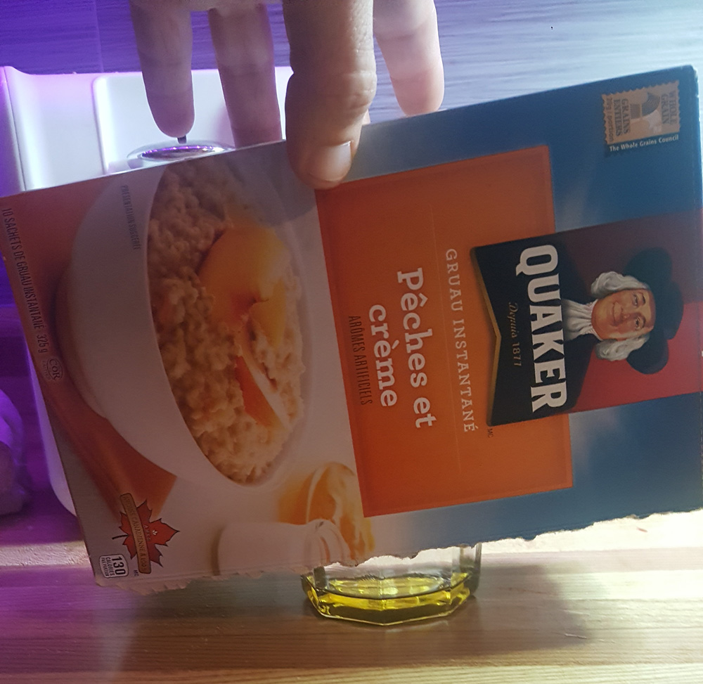 Box covering glass filled with water and seeds from light